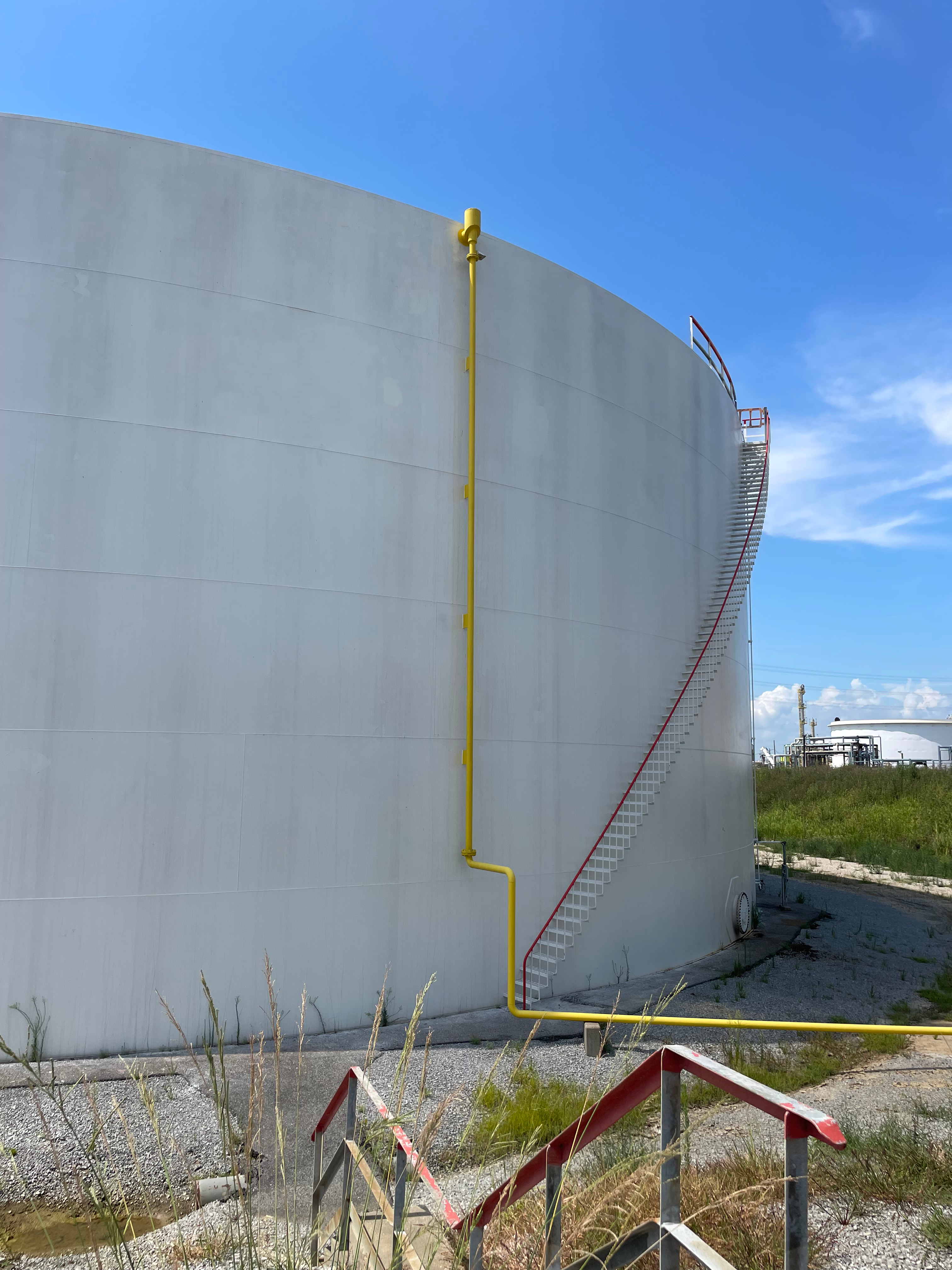 The very good condition of a white coating on the outside of a storage tank one year after application.