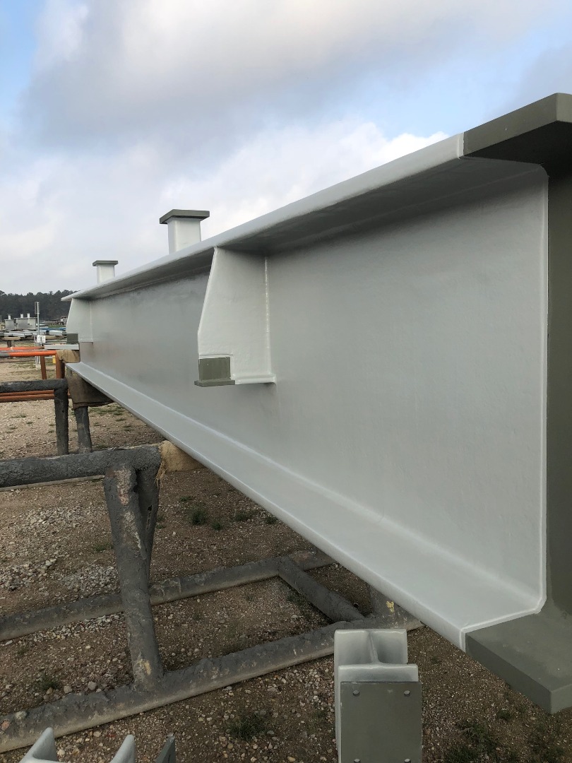 A steel column coated in Thermo-Lag E100, a two-component epoxy intumescent fire-resistive material.